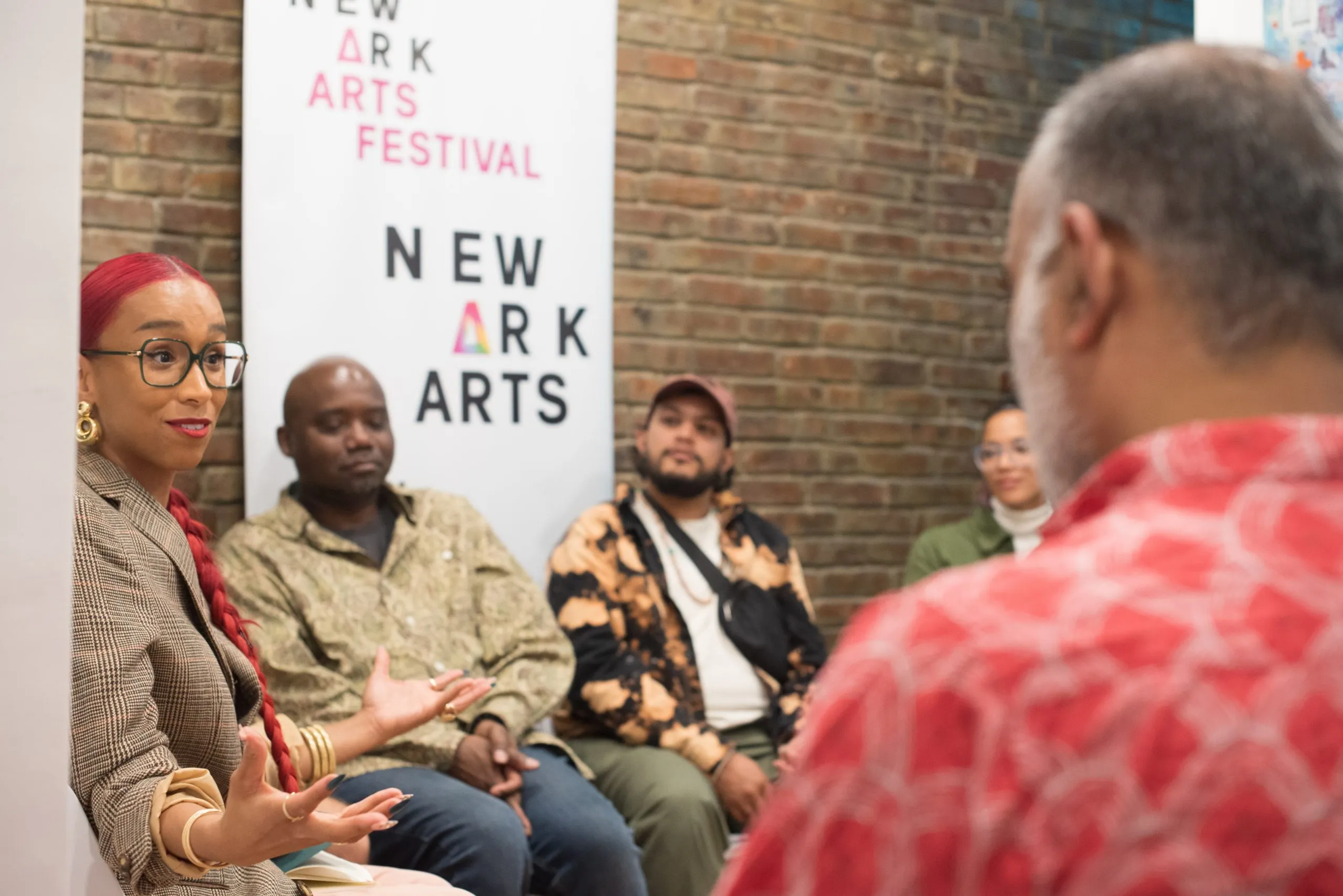 Engaged speakers share insights during an art and wellness event at The 7 Space.