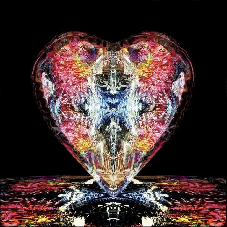 Shaped glass art with vibrant, colorful reflections on a black background.