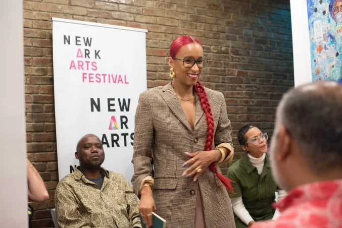 Art gallery and wellness event at The 7 Space in downtown Newark with diverse attendees.